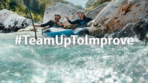 Two kayakers overcoming rapids