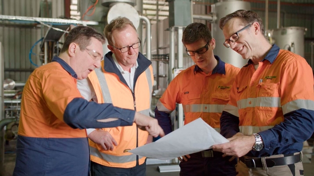 Team from Wildfire Energy Australia discussing the buildup and processes of their pilot plant.